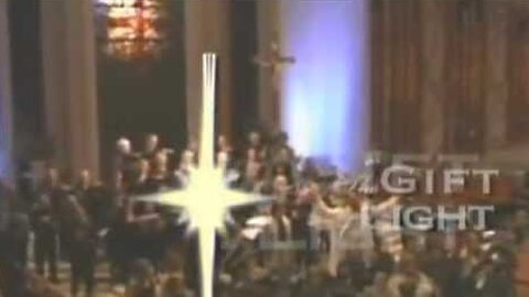 A choir at the front of a full church, behind a bright star and the faded title “The Gift of Light.”
