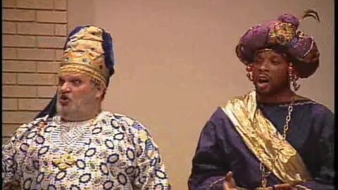 Two of the kings, in jeweled headdresses and rich robes, singing.